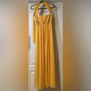 Yellow long prom dress with embroidered torso.